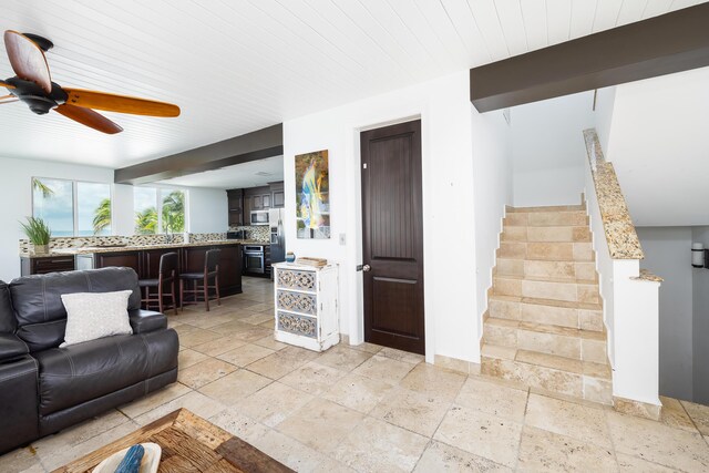 living room featuring wood ceiling, ceiling fan, and beam ceiling