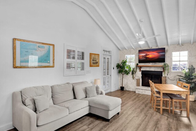 71 N Bay Harbor Dr, Key Largo, FL 33037 - living area featuring a fireplace, wood finished floors, and a ceiling fan