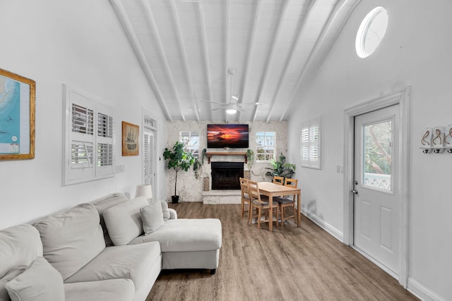 71 N Bay Harbor Dr, Key Largo, FL 33037 - living room with wood finished floors, a stone fireplace, and ceiling fan