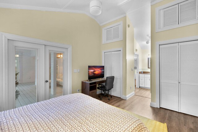 71 N Bay Harbor Dr, Key Largo, FL 33037 - bedroom featuring wood finished floors, high vaulted ceiling, ensuite bathroom, and crown molding