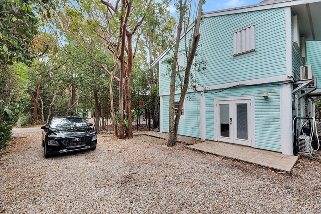 71 N Bay Harbor Dr, Key Largo, FL 33037 - view of side of property with french doors