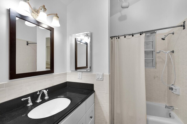 71 N Bay Harbor Dr, Key Largo, FL 33037 - full bathroom with shower / bath combo with shower curtain, vanity, and tile walls