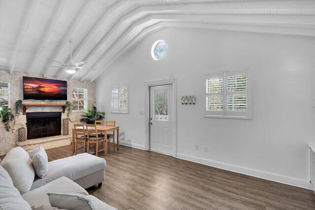71 N Bay Harbor Dr, Key Largo, FL 33037 - living room with a stone fireplace, high vaulted ceiling, wood finished floors, a ceiling fan, and beamed ceiling