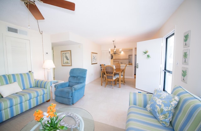 living room featuring ceiling fan with notable chandelier