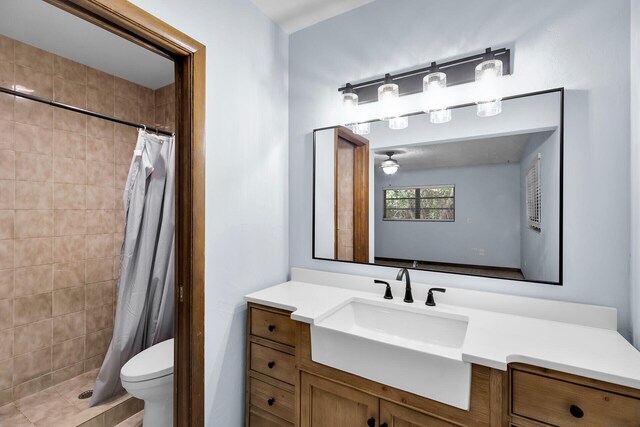 bathroom featuring vanity, toilet, tile patterned flooring, and a shower with shower curtain