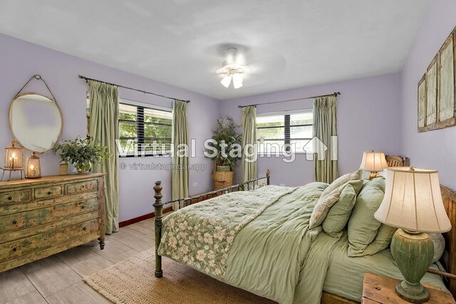 bedroom with multiple windows and light wood-type flooring