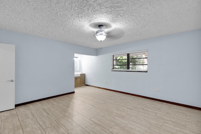 spare room featuring a textured ceiling and ceiling fan