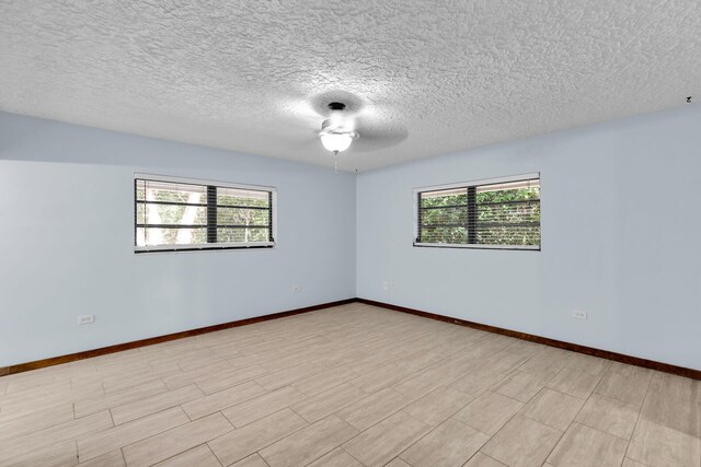 unfurnished room featuring a textured ceiling and light wood-type flooring