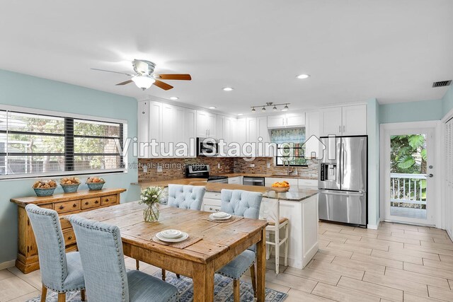 dining area with sink and ceiling fan