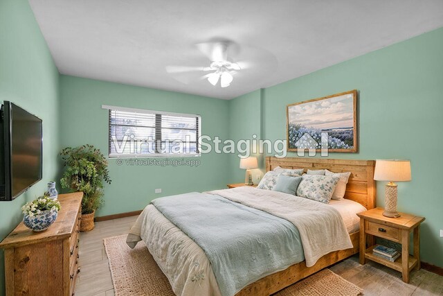 bedroom with ceiling fan and light wood-type flooring