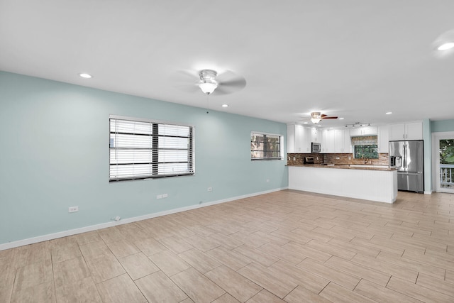 unfurnished living room featuring light hardwood / wood-style floors and ceiling fan