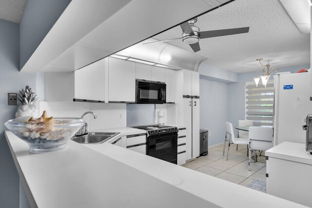 87851 Old Hwy Unit K26, Islamorada, FL 33036 - kitchen featuring black appliances, ceiling fan, light countertops, white cabinets, and a textured ceiling