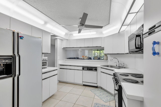 87851 Old Hwy Unit K26, Islamorada, FL 33036 - kitchen with white appliances, light countertops, a textured ceiling, ceiling fan, and light tile patterned flooring
