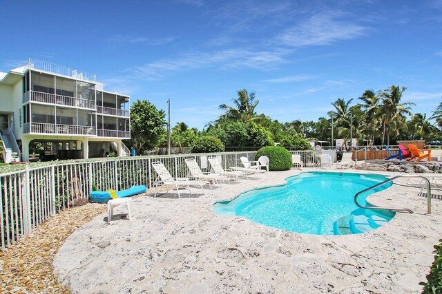 view of swimming pool featuring a patio area