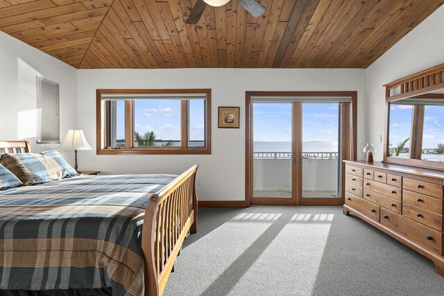 carpeted bedroom featuring ceiling fan, lofted ceiling, ensuite bathroom, and wood ceiling