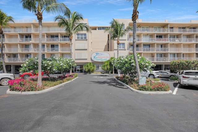 view of building exterior featuring uncovered parking