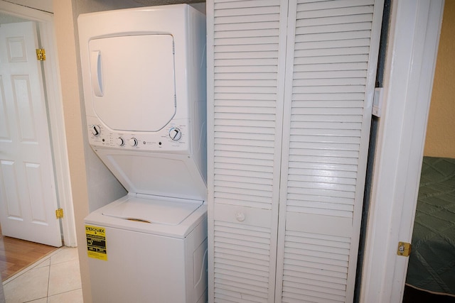 104350 Overseas Hwy Unit B205, Key Largo, FL 33037 - washroom featuring stacked washer / dryer and tile patterned flooring