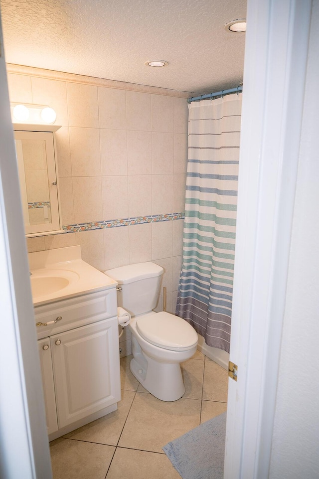104350 Overseas Hwy Unit B205, Key Largo, FL 33037 - full bathroom featuring a textured ceiling, vanity, tile patterned floors, tile walls, and recessed lighting