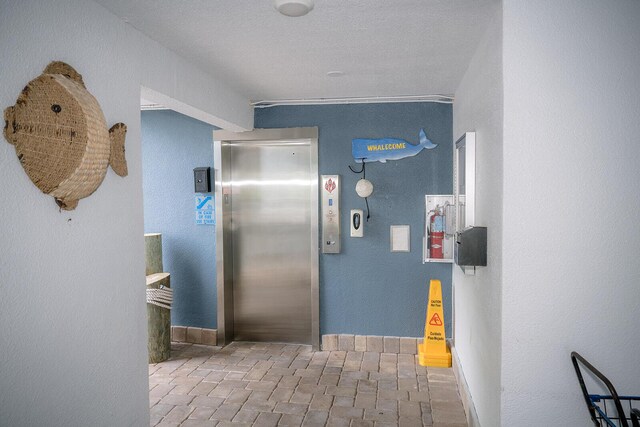104350 Overseas Hwy Unit B205, Key Largo, FL 33037 - hall with elevator and a textured wall