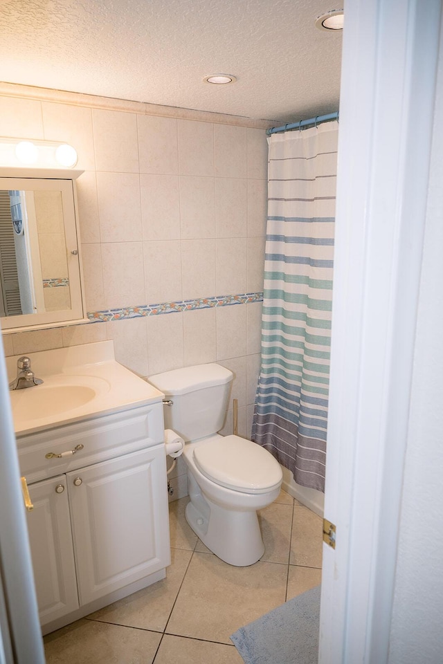 104350 Overseas Hwy Unit B205, Key Largo, FL 33037 - full bathroom featuring a textured ceiling, vanity, tile patterned floors, tile walls, and a shower with curtain