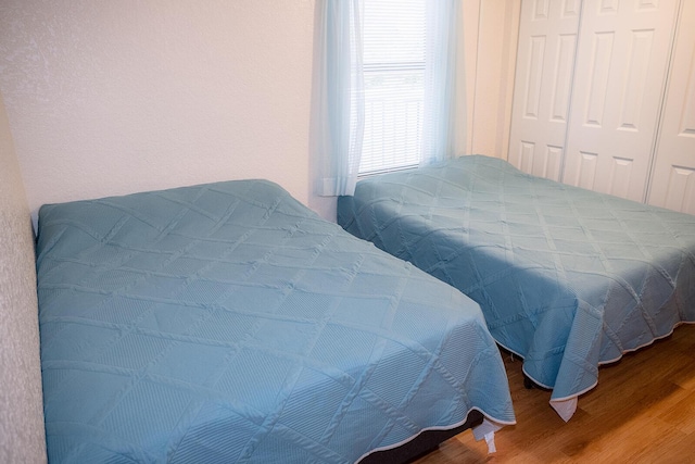 104350 Overseas Hwy Unit B205, Key Largo, FL 33037 - bedroom featuring wood finished floors and a closet