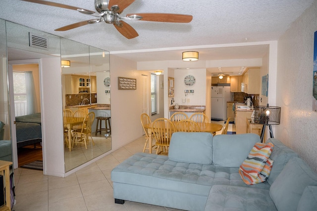 104350 Overseas Hwy Unit B205, Key Largo, FL 33037 - living room with light tile patterned flooring, a textured ceiling, and ceiling fan