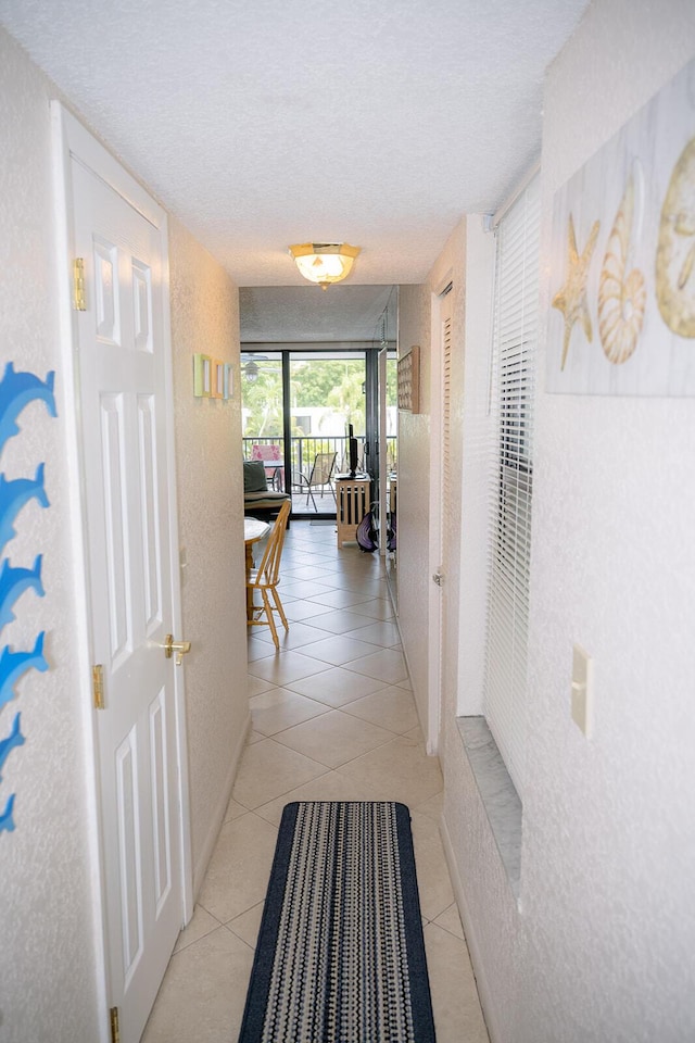 104350 Overseas Hwy Unit B205, Key Largo, FL 33037 - corridor with a textured ceiling and light tile patterned floors