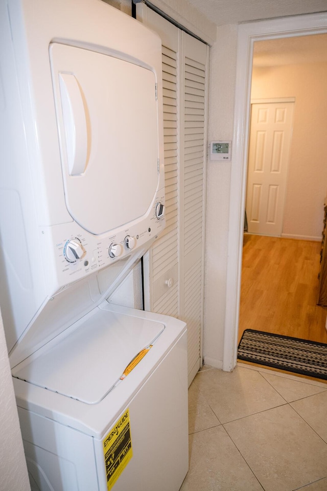 104350 Overseas Hwy Unit B205, Key Largo, FL 33037 - laundry area featuring estacked washer and dryer and light tile patterned flooring