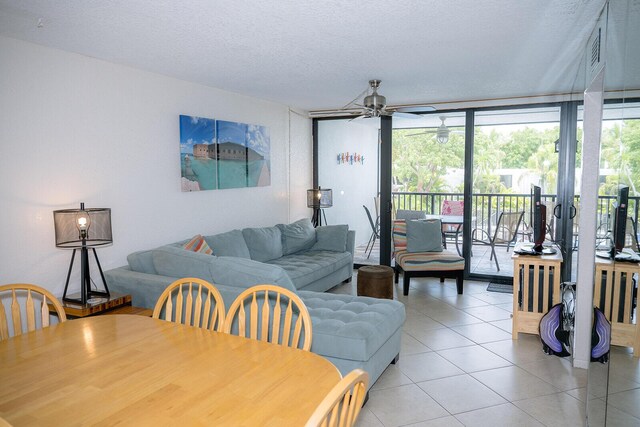 104350 Overseas Hwy Unit B205, Key Largo, FL 33037 - dining room featuring ceiling fan, light tile patterned floors, a wall of windows, and a textured ceiling