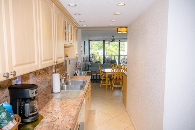 104350 Overseas Hwy Unit B205, Key Largo, FL 33037 - kitchen featuring backsplash, recessed lighting, light tile patterned floors, light countertops, and glass insert cabinets