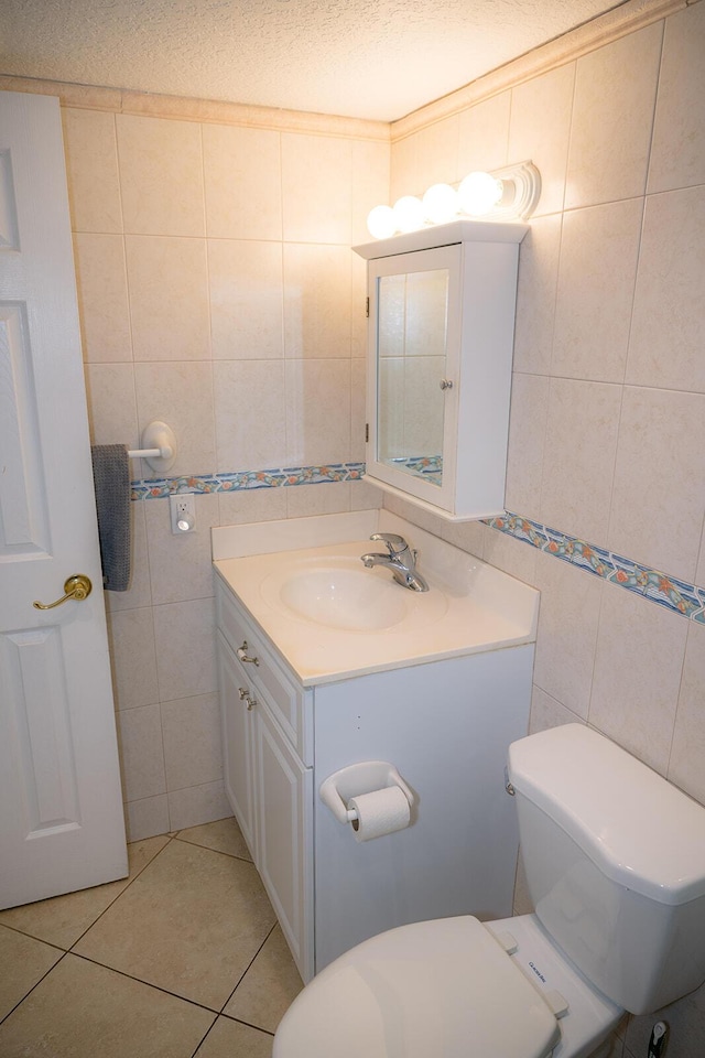104350 Overseas Hwy Unit B205, Key Largo, FL 33037 - half bathroom featuring tile walls, vanity, tile patterned flooring, and a textured ceiling