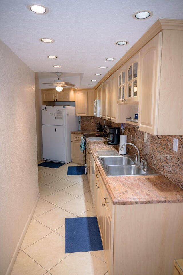 104350 Overseas Hwy Unit B205, Key Largo, FL 33037 - kitchen featuring white appliances, tasteful backsplash, light brown cabinets, glass insert cabinets, and light tile patterned flooring