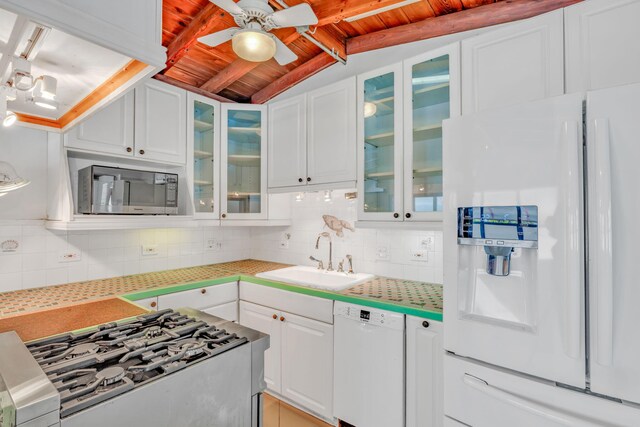 140 Gardenia St, Tavernier, FL 33070 - kitchen featuring white appliances, a sink, wood ceiling, backsplash, and a ceiling fan