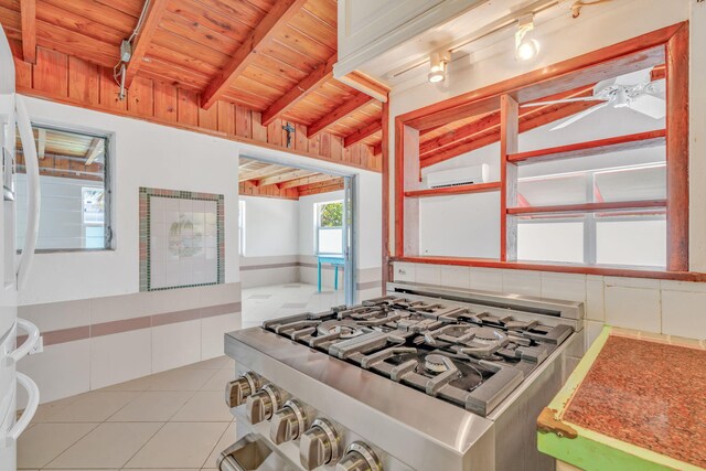 140 Gardenia St, Tavernier, FL 33070 - kitchen featuring wooden ceiling, a wall mounted air conditioner, gas range, tile patterned floors, and freestanding refrigerator