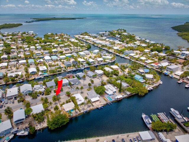 140 Gardenia St, Tavernier, FL 33070 - aerial view of property and surrounding area featuring a large body of water and nearby suburban area