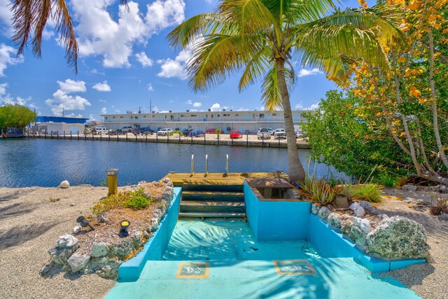 140 Gardenia St, Tavernier, FL 33070 - view of pool featuring a boat dock and a water view