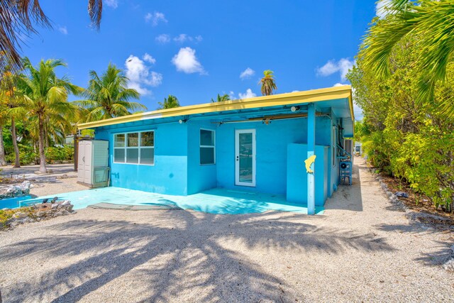 140 Gardenia St, Tavernier, FL 33070 - rear view of property with stucco siding