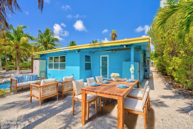 140 Gardenia St, Tavernier, FL 33070 - view of patio / terrace featuring an outdoor living space and outdoor dining space