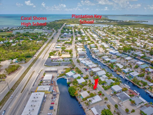 140 Gardenia St, Tavernier, FL 33070 - aerial view of property and surrounding area with a large body of water, nearby suburban area, and a major roadway