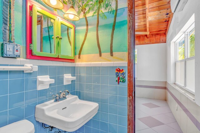 140 Gardenia St, Tavernier, FL 33070 - half bath with a sink, wood ceiling, a wall mounted AC, toilet, and wainscoting