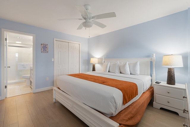 bedroom featuring connected bathroom, light hardwood / wood-style flooring, ceiling fan, and a closet