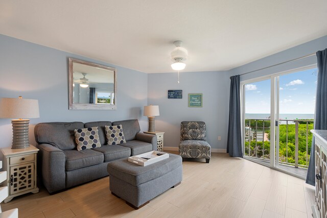 living room with light hardwood / wood-style flooring and ceiling fan