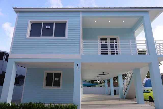 exterior space with ceiling fan and a carport