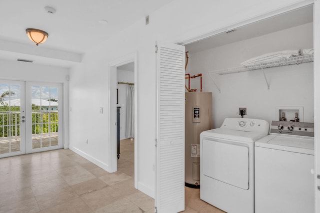 laundry area with washer and dryer, water heater, and french doors