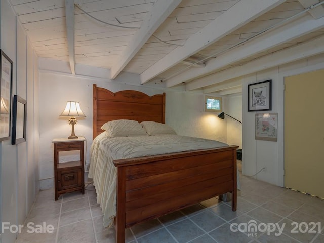 tiled bedroom featuring beamed ceiling