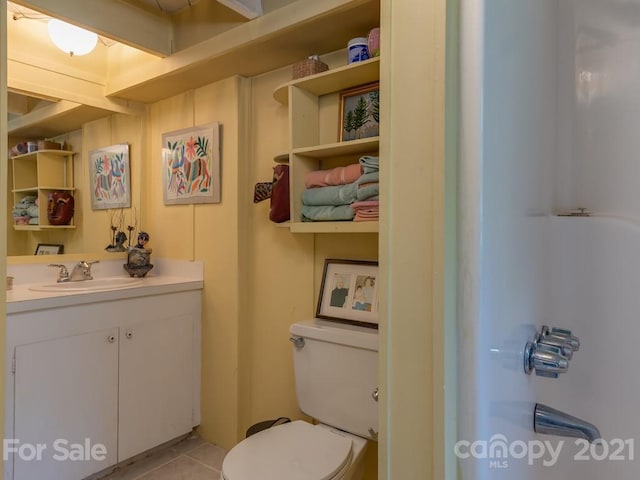 bathroom featuring tile floors, toilet, and vanity