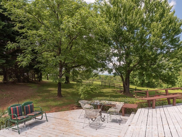 wooden terrace with a lawn