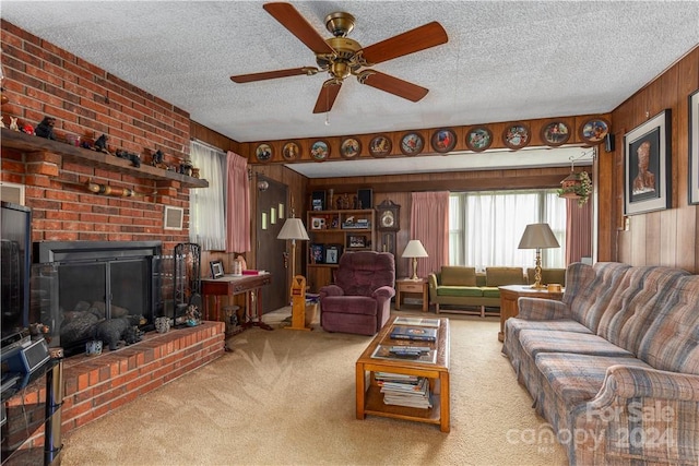 living room featuring light carpet, a fireplace, a textured ceiling, and wood walls