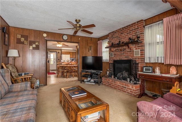 living room featuring a brick fireplace, light colored carpet, a textured ceiling, and wood walls