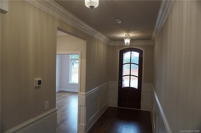 entryway featuring ornamental molding and dark hardwood / wood-style floors